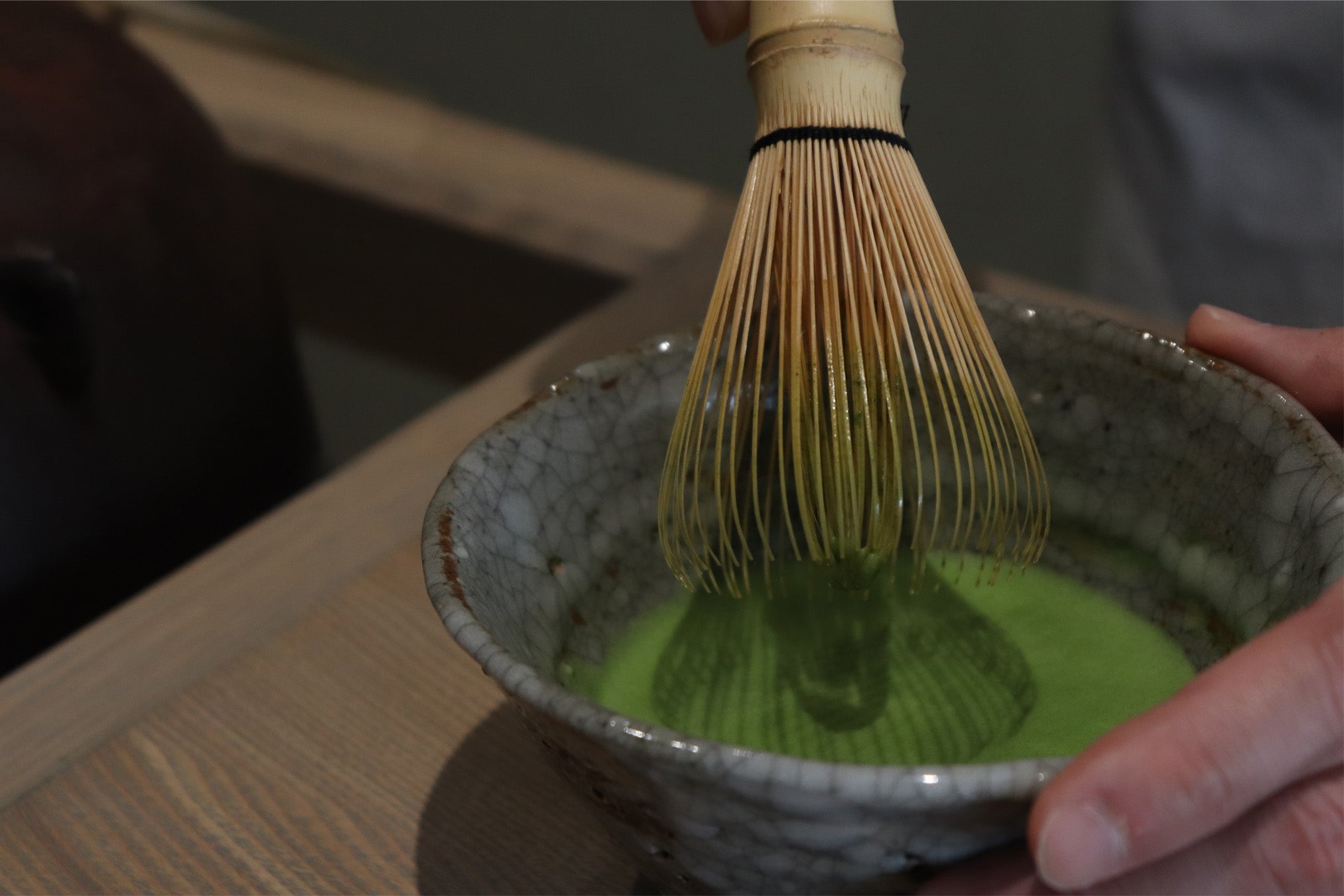 Whisking vibrant matcha with a handcrafted bamboo chasen. Create smooth, frothy tea and enjoy an authentic Japanese tea ceremony experience.